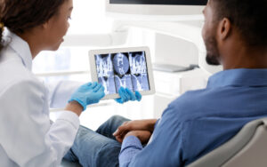 Patient receiving a digital dental exam using modern imaging technology